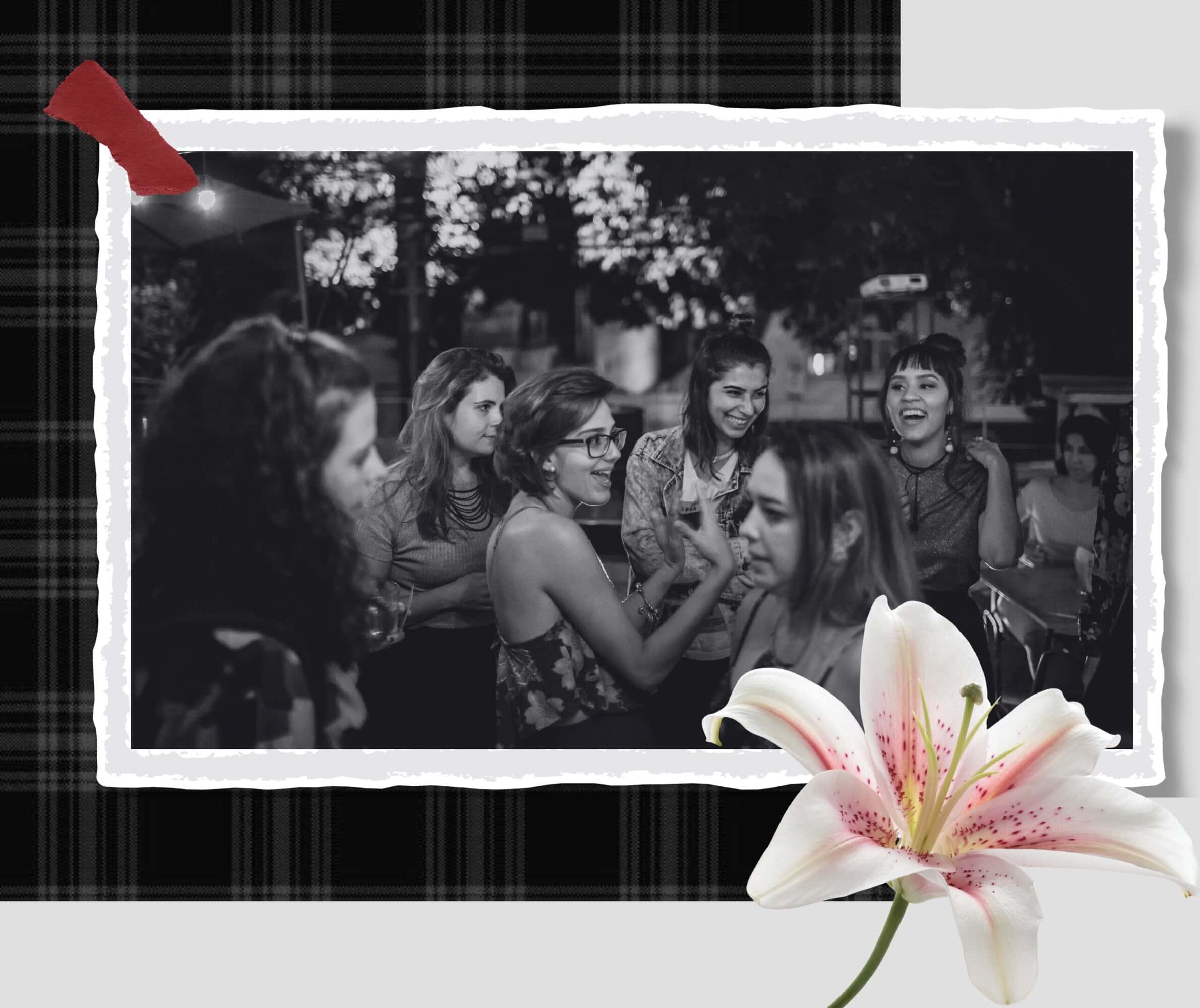 Enjoying a lively outdoor evening with friends at a social gathering, captured in a stylish black-and-white photo.