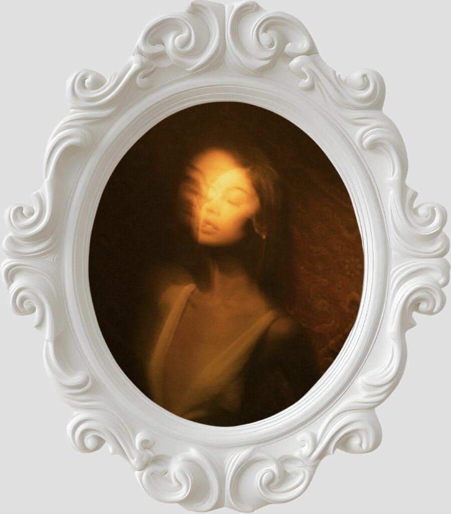1. Ethereal woman’s portrait mirrored in vintage ornate frame with warm lighting.