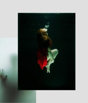Refined red dress woman underwater, artistic photography, moody and mysterious vibe, fashion and creative concept.